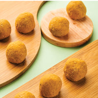 Heerson Besan Ladoo. Cardamom and nuts adorned.